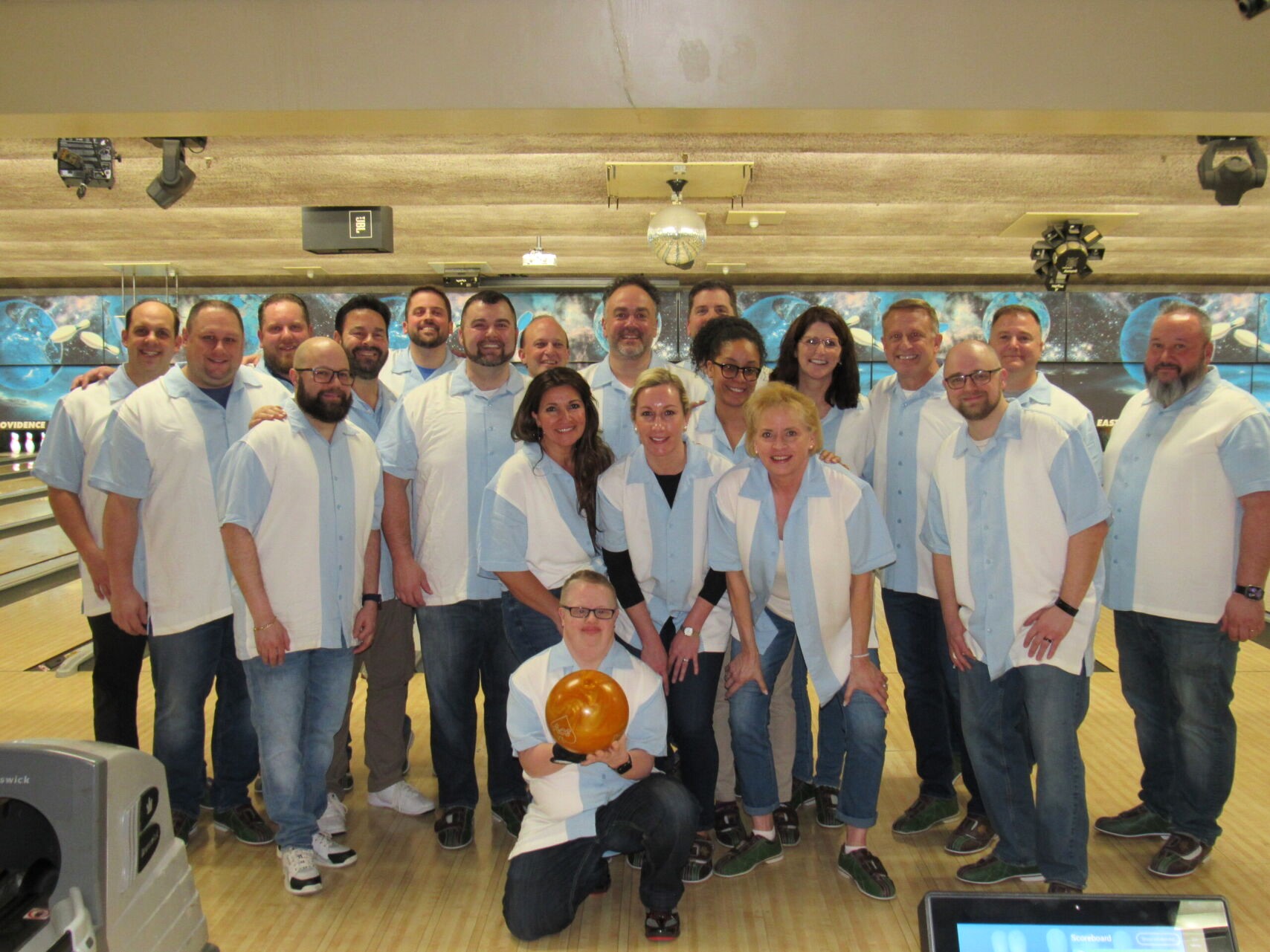 attendees at bowling community event posing for picture