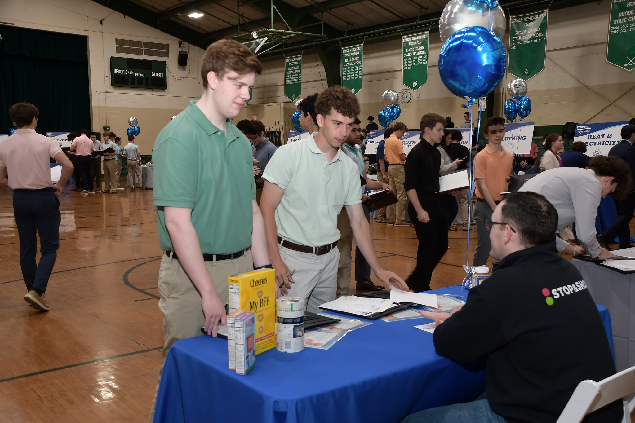 Students meeting with Grant Gray, Store Manager, Stop and Shop learning budgeting for grocery store options