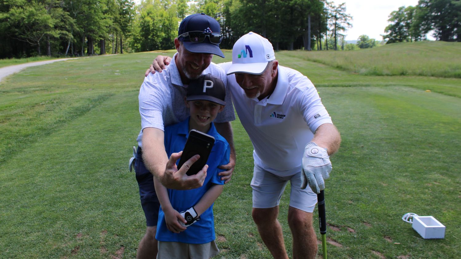 players taking selfie with kid