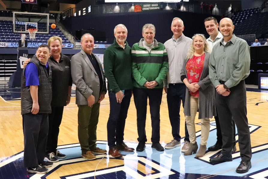 A group of people standing in a basketball court
Description automatically generated